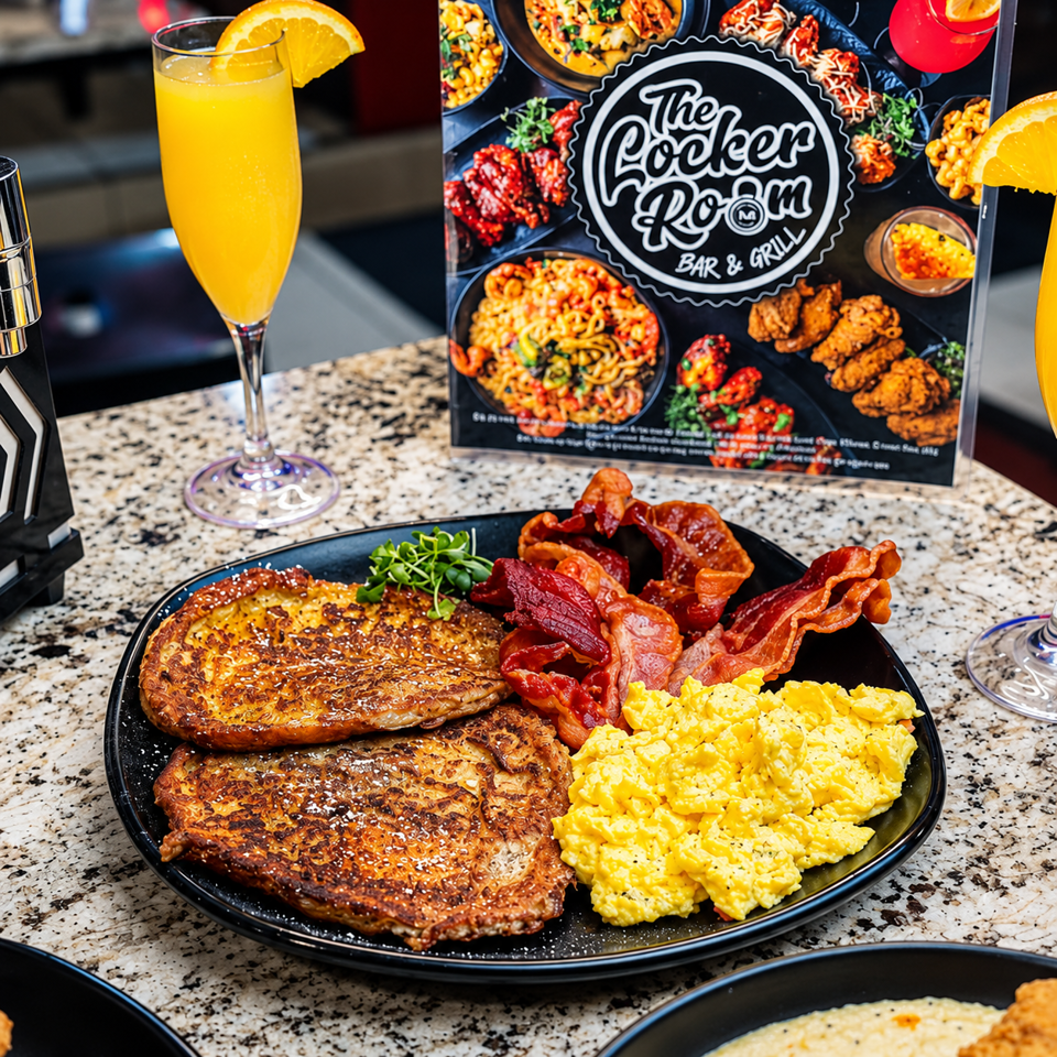 Breakfast platter with French toast, scrambled eggs, bacon, orange juice, and The Cooker Room Bar & Grill menu in the background
